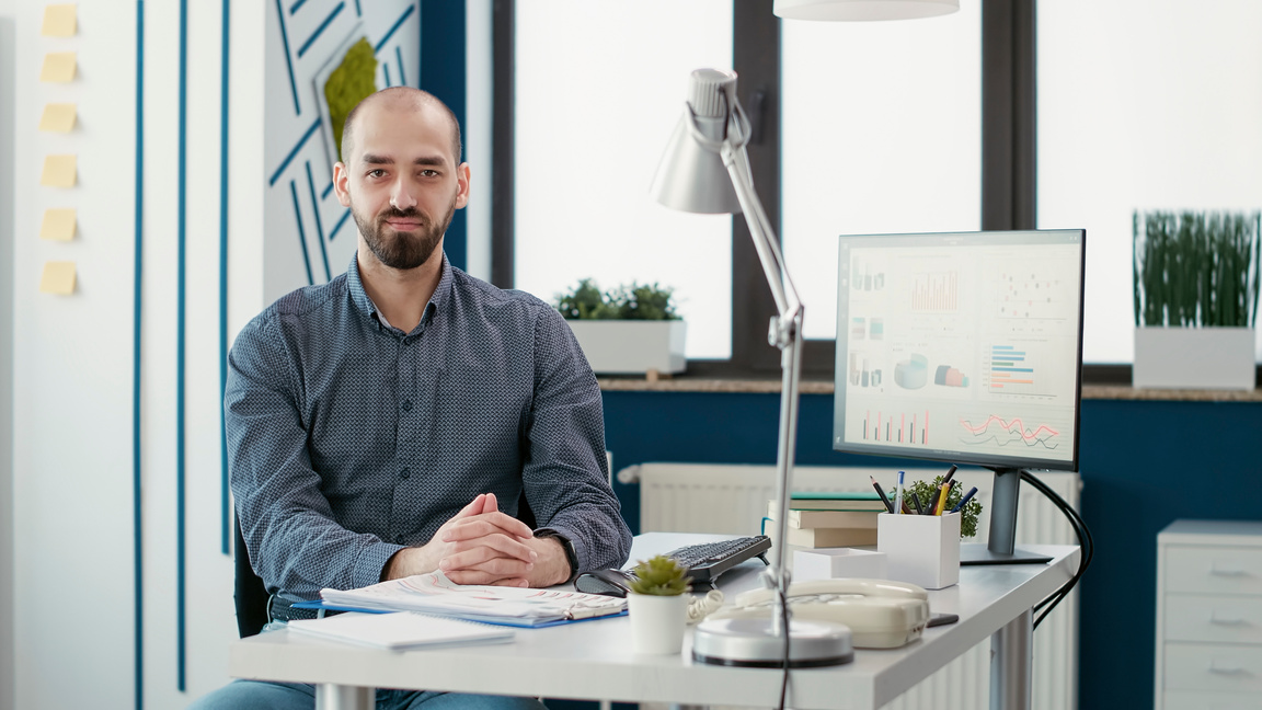 Executive assistant doing data research on computer with sales report